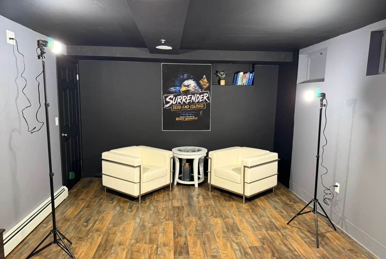Professional podcast set with studio lighting and Surrender Dead End Kulture branded backdrop