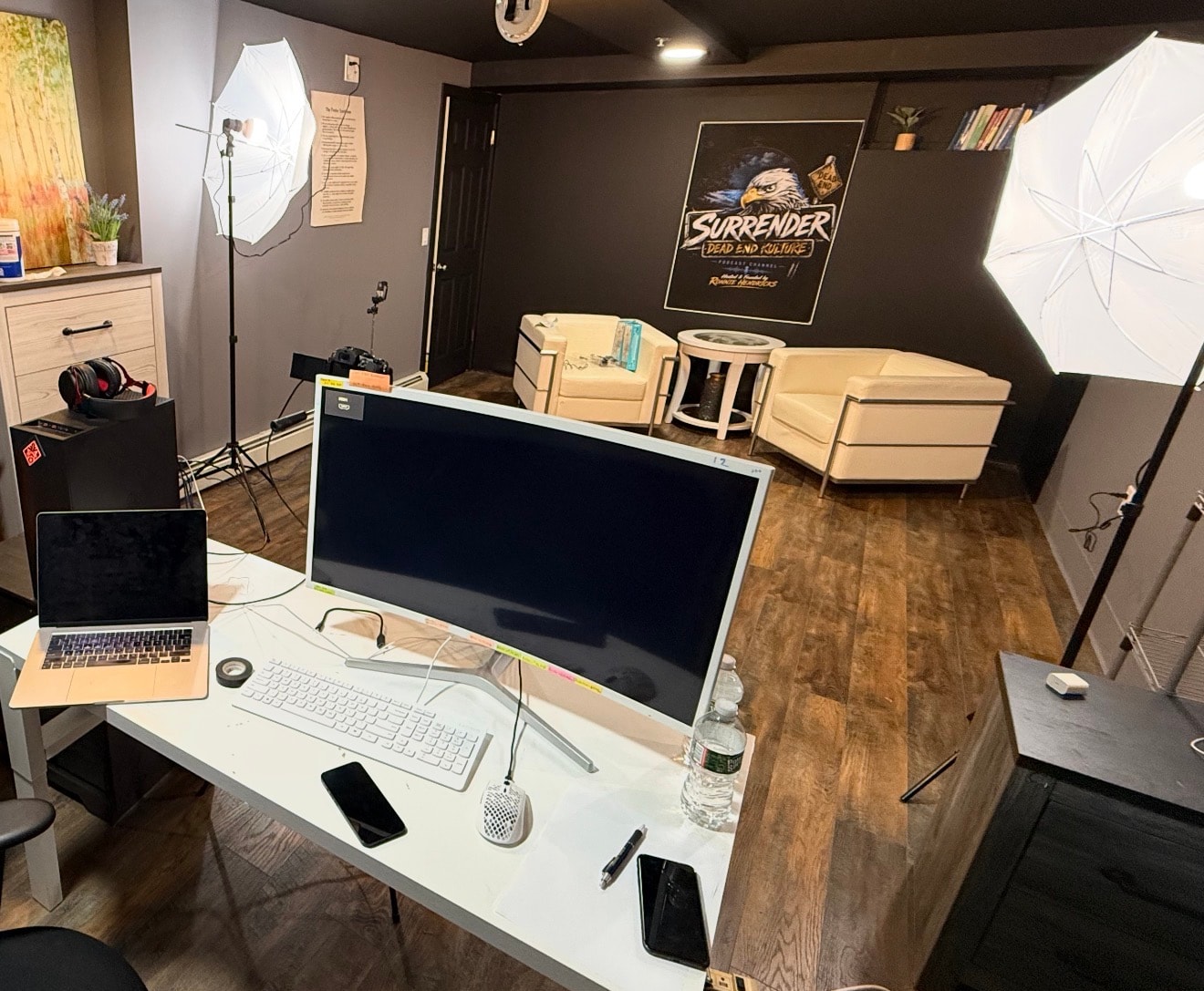 Ema Media Group studio workspace with production monitors, lighting equipment, and podcast seating area